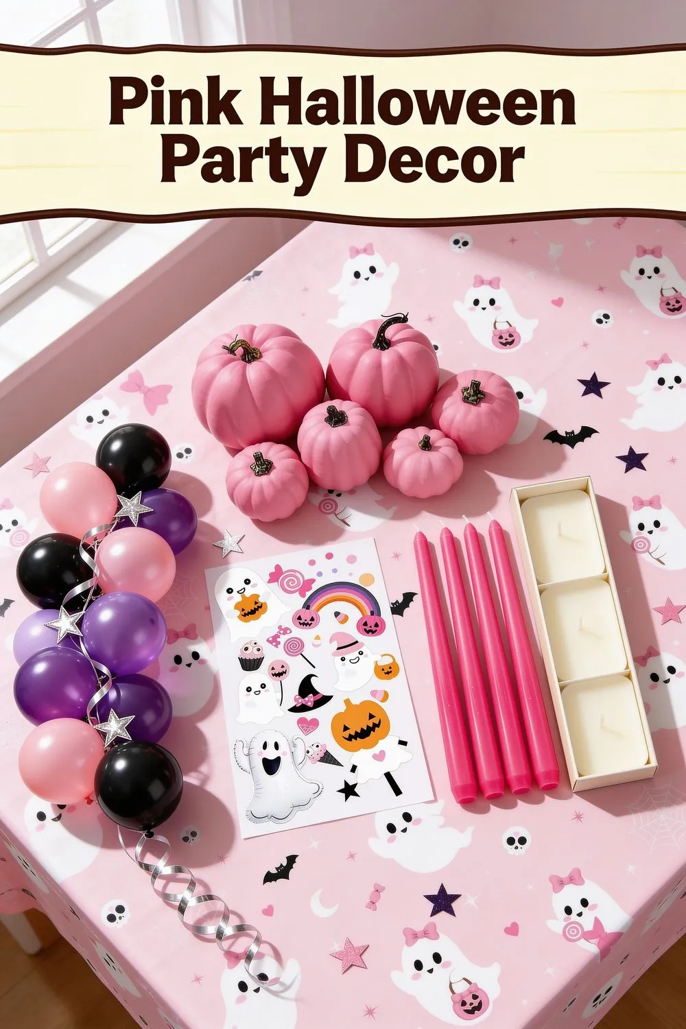 Overhead photo of a pink ghost print tablecloth with hot pink pumpkins, pink, purple and black balloons, a sheet of ghost window clings and four hot pink taper candles.